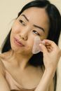 Smiling woman giving herself facial massage
