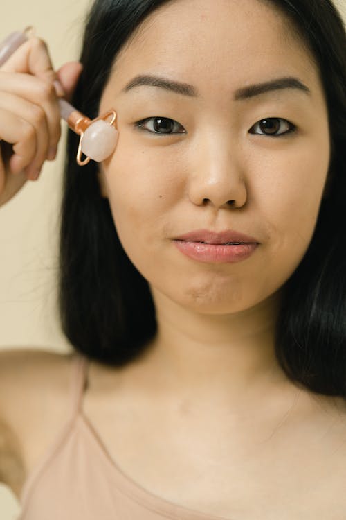 Woman using face roller