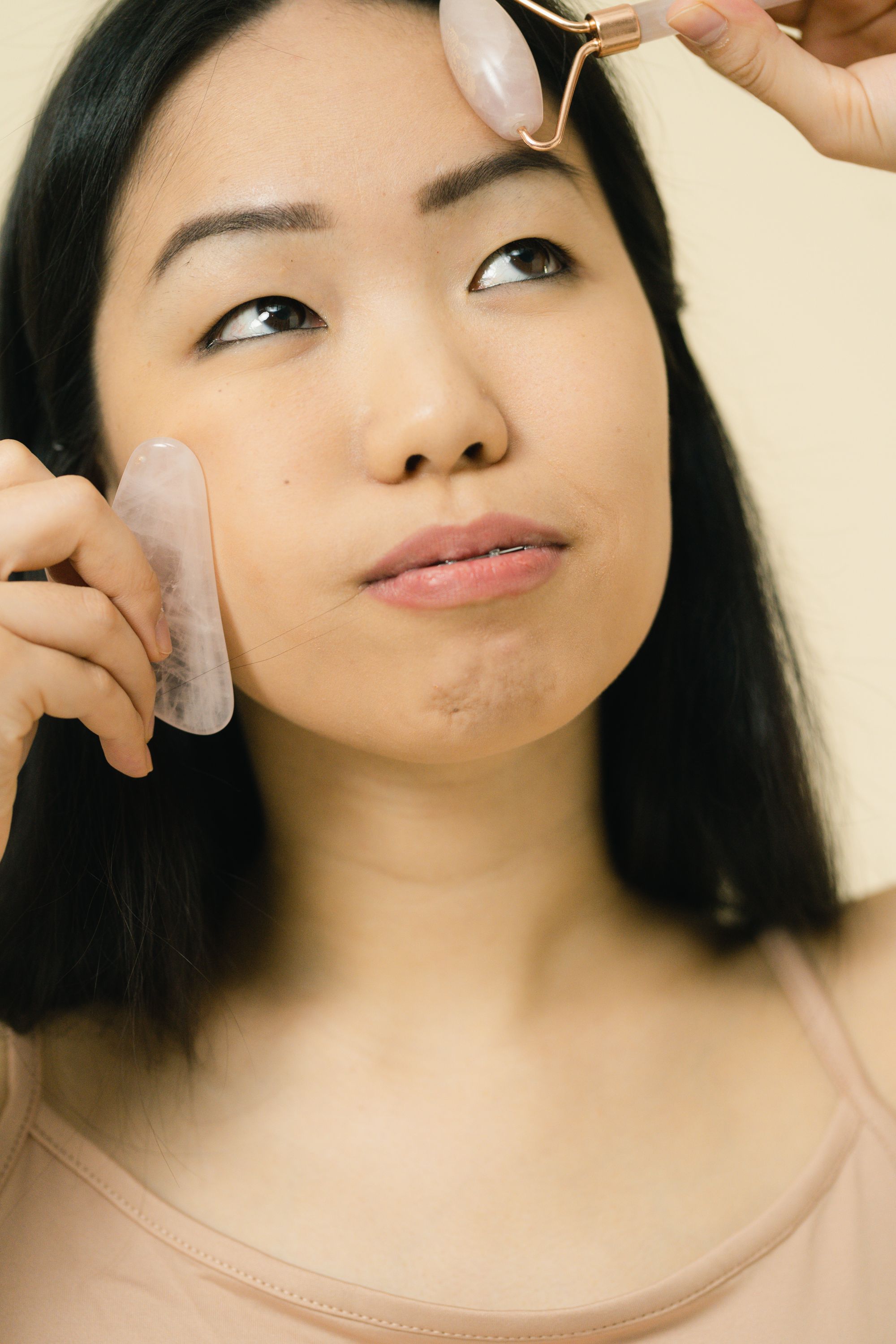 Asian woman using professional skincare tools