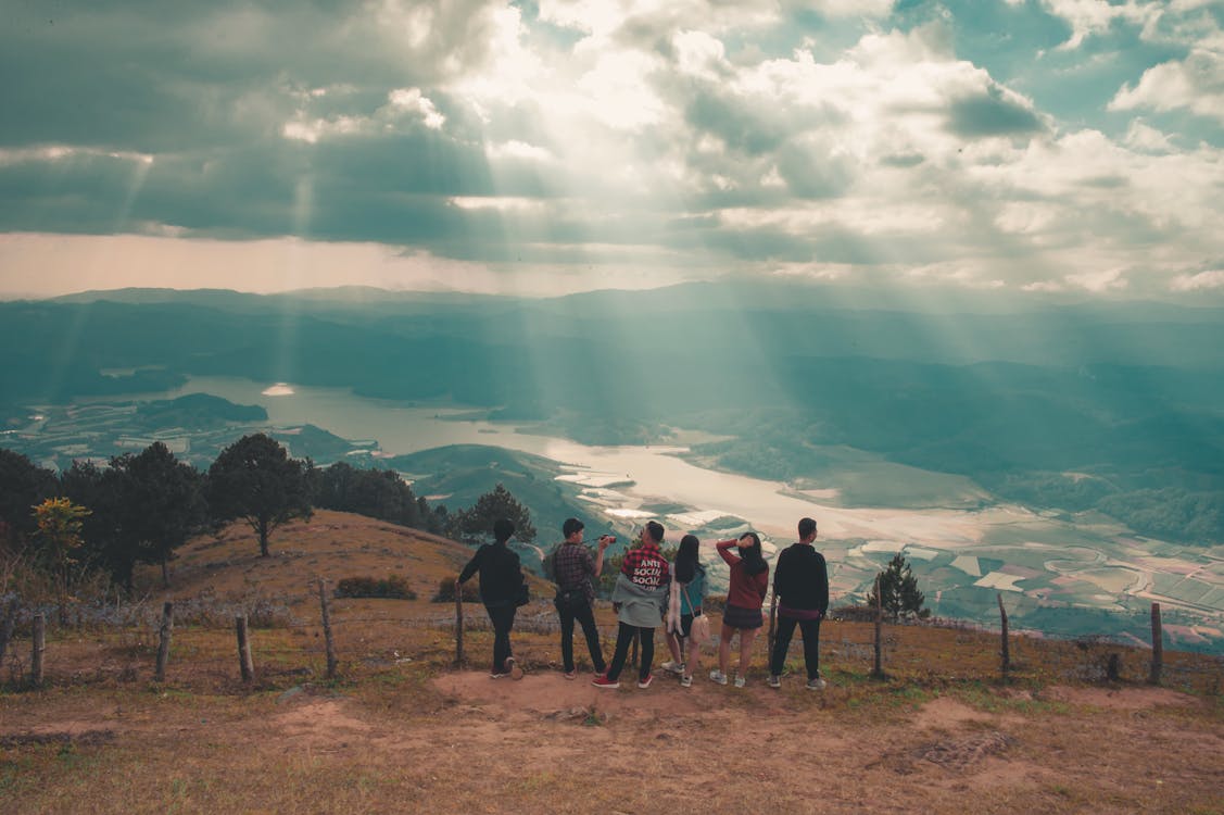 Group of People Standing Near Fence