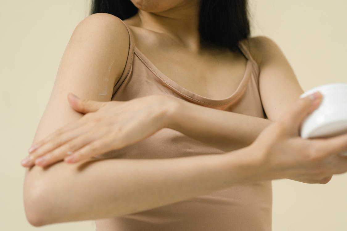 Woman massaging cosmetic product into her skin