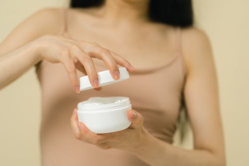 Free Woman opening cosmetic container Stock Photo
