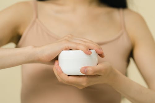 Woman holding cosmetic container