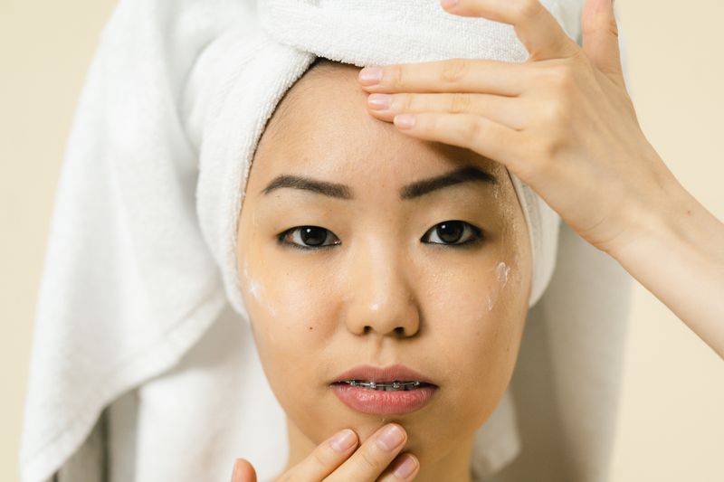 Woman applying facial cream during skincare routine