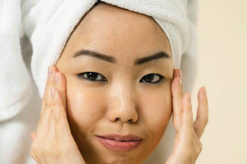 Close up view of woman with hair wrapped in towel