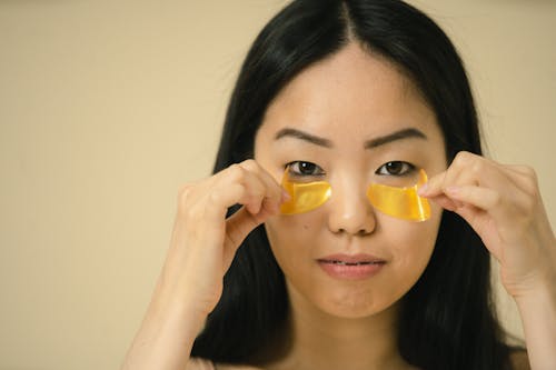 Close up view of woman holding cosmetic masks