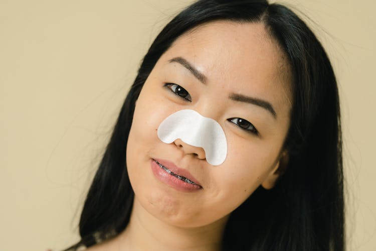 Woman With Face Mask On Her Nose