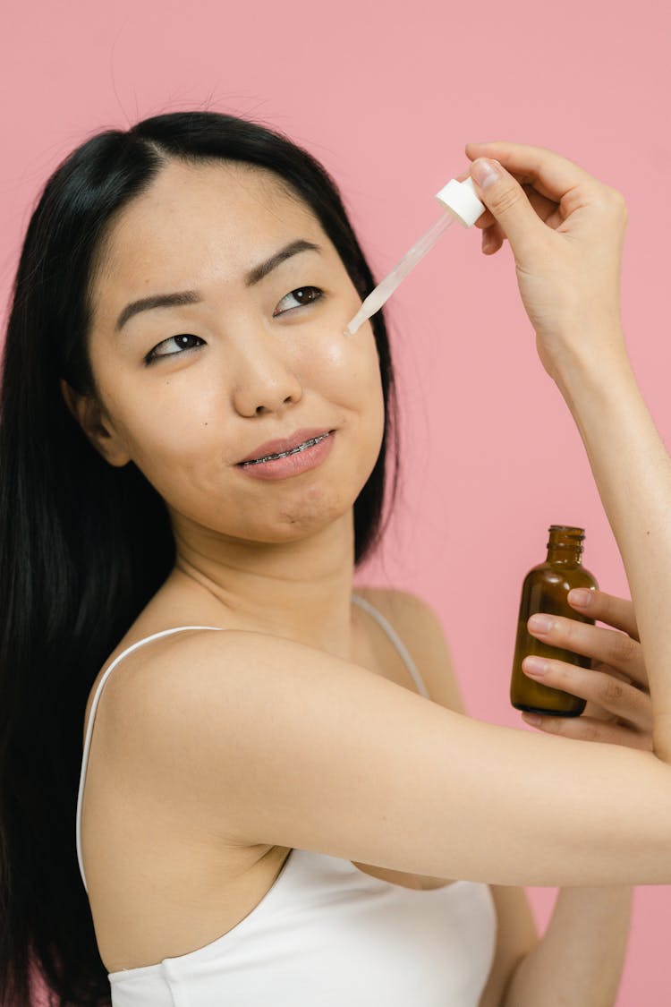 Woman Applying Cosmetic Product Under Her Eye