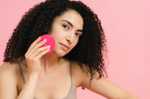 Woman Holding a Facial Cleanser