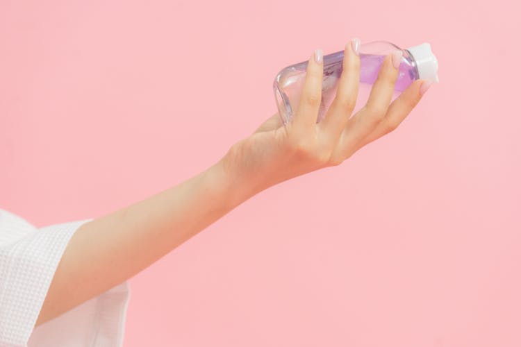 Plastic Cosmetic Bottle In Hand