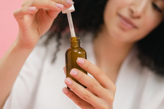 Close-up of a woman using a dropper bottle, focusing on skincare and beauty routine.