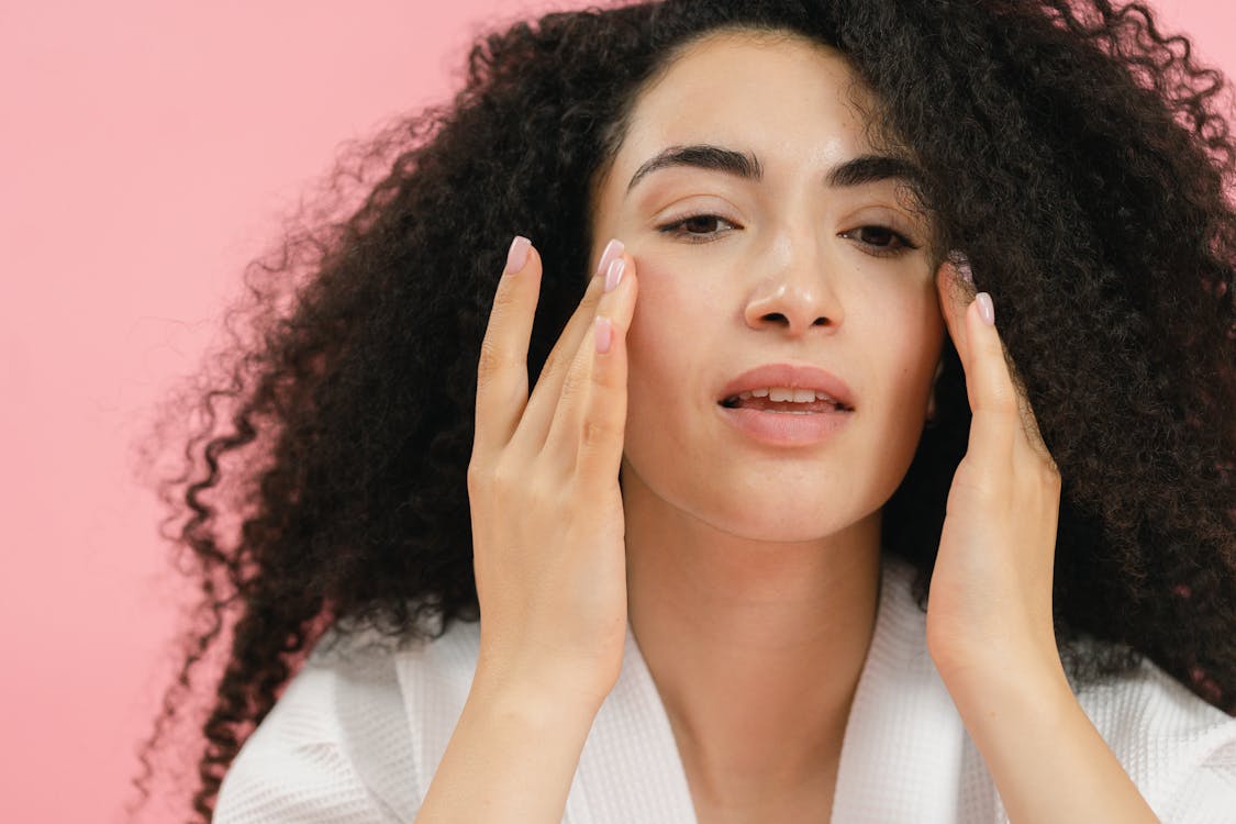 A person examining their face after the PRP facial treatment