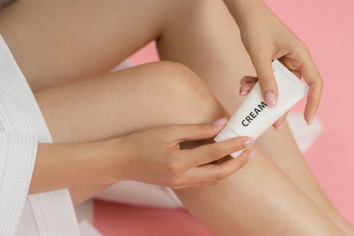 Close-up of Woman Holding Cream in a Tube 