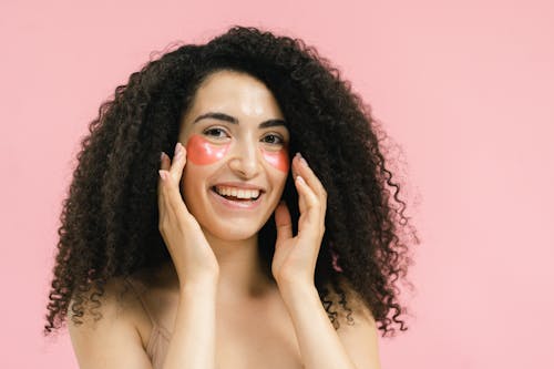 A Smiling Woman Wearing an Eye Mask