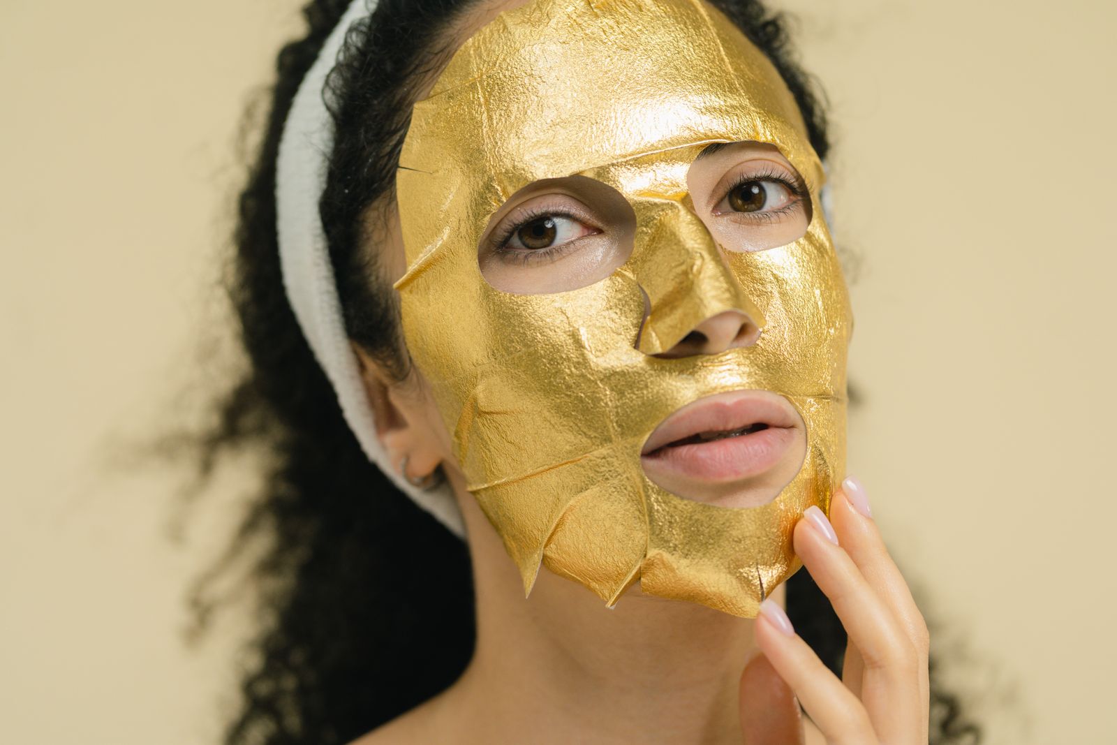 Woman touching her radiant face in warm golden light