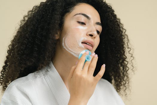 A woman uses a facial cleansing brush as part of her skincare routine, focusing on self-care and healthy skin.