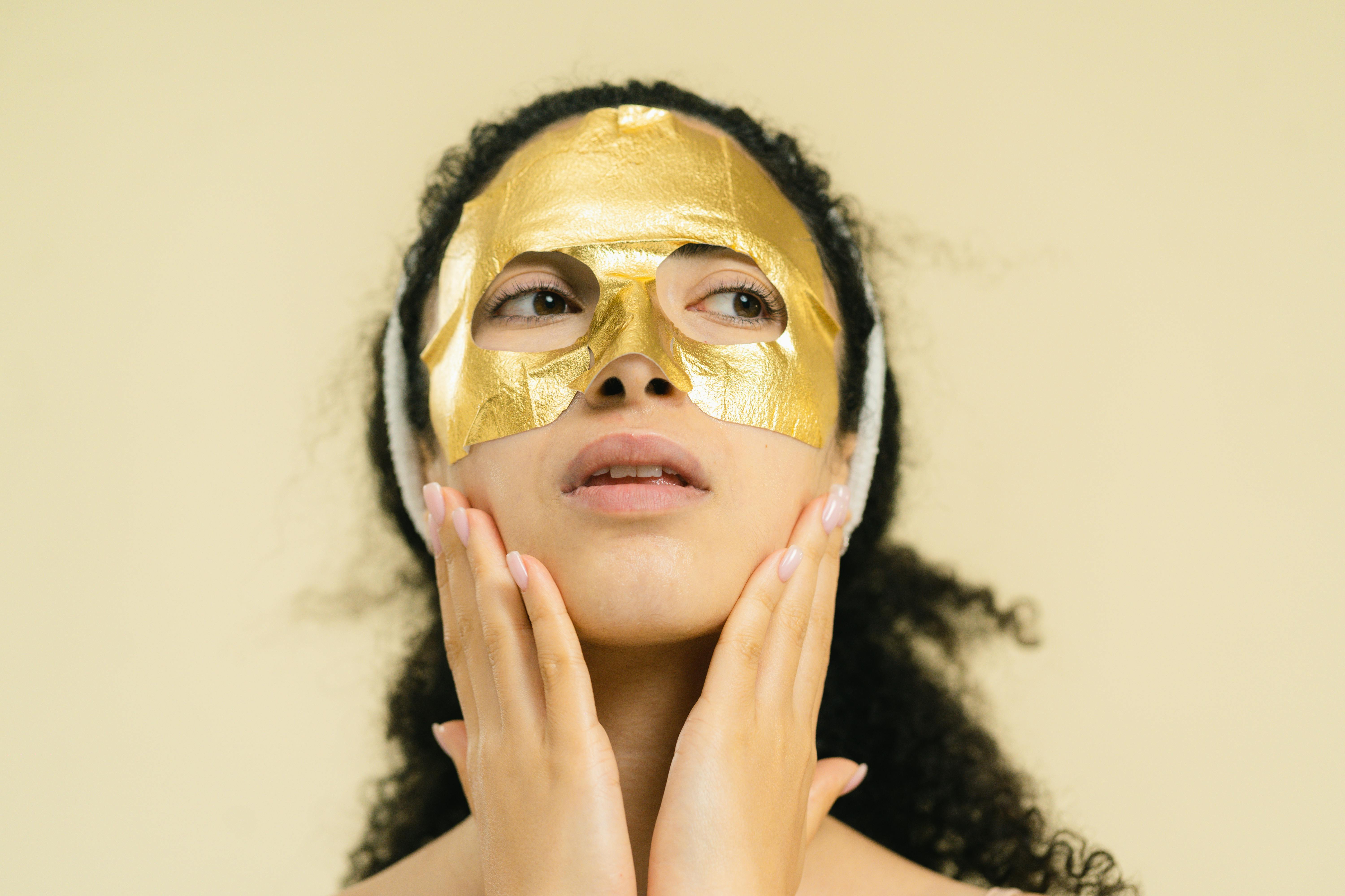 woman wearing a golden face mask