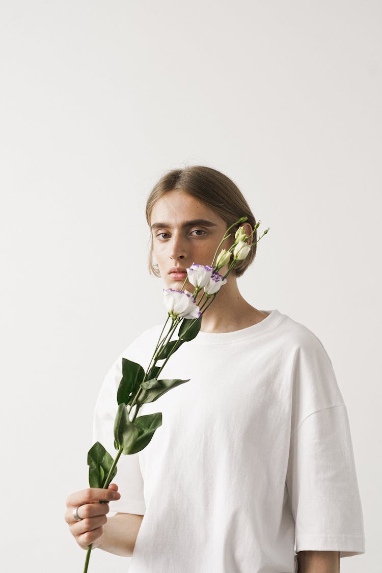 Young Brunette Person With Flowers In Hand