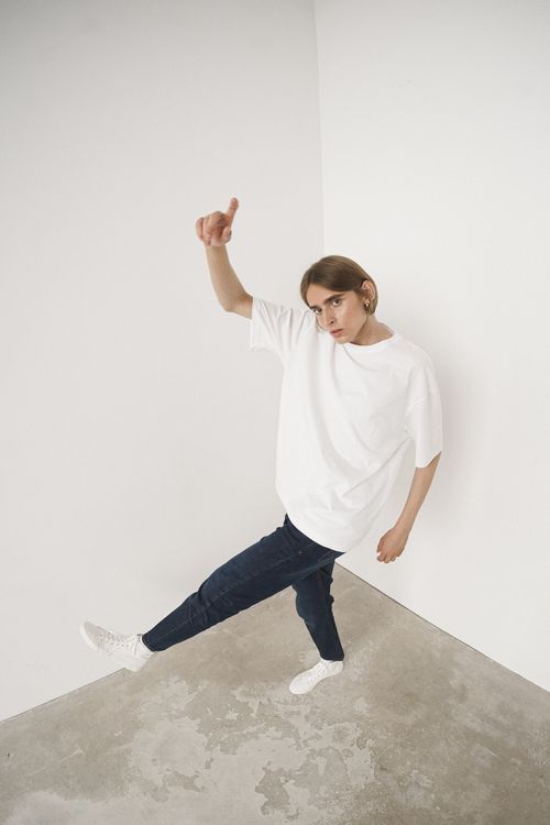 Free High angle view of a man in casual attire posing indoors against a white wall. Stock Photo