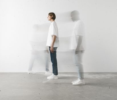 Ethereal long exposure shot of a person moving indoors, creating a ghostly effect.