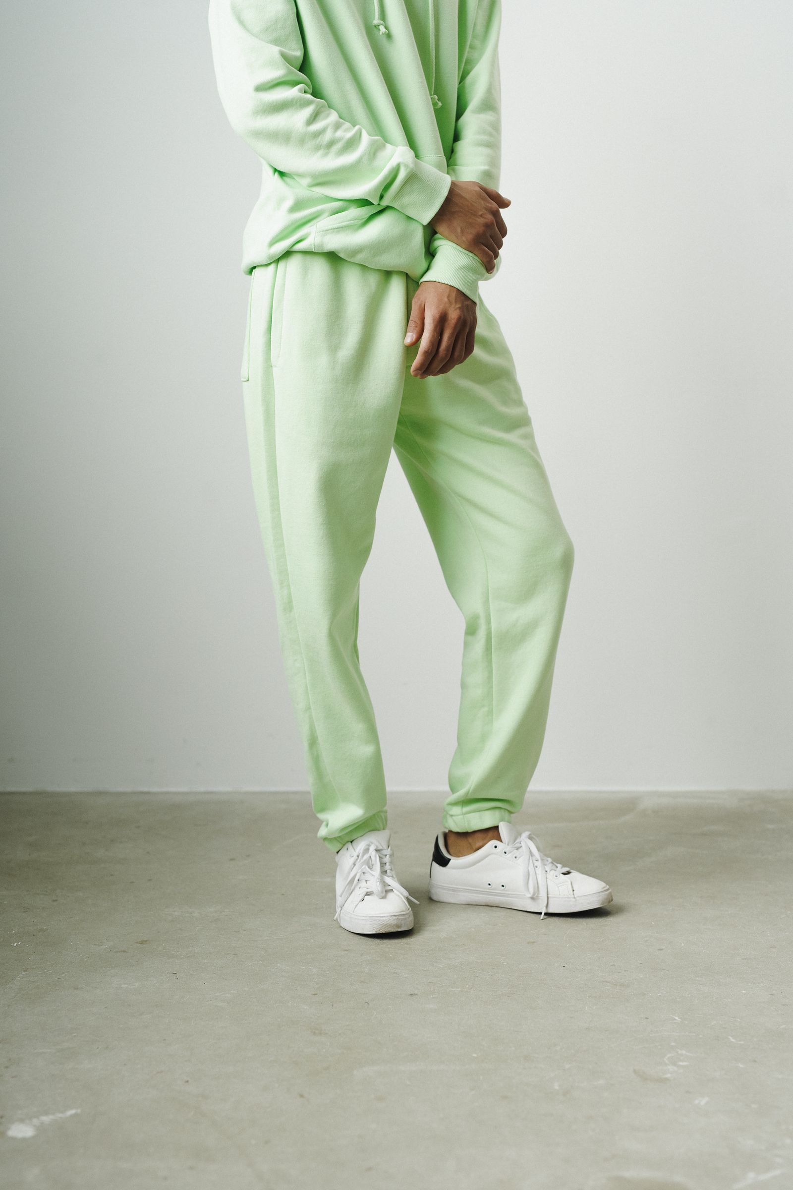 Model wearing a coordinated tracksuit and joggers in a modern athleisure style