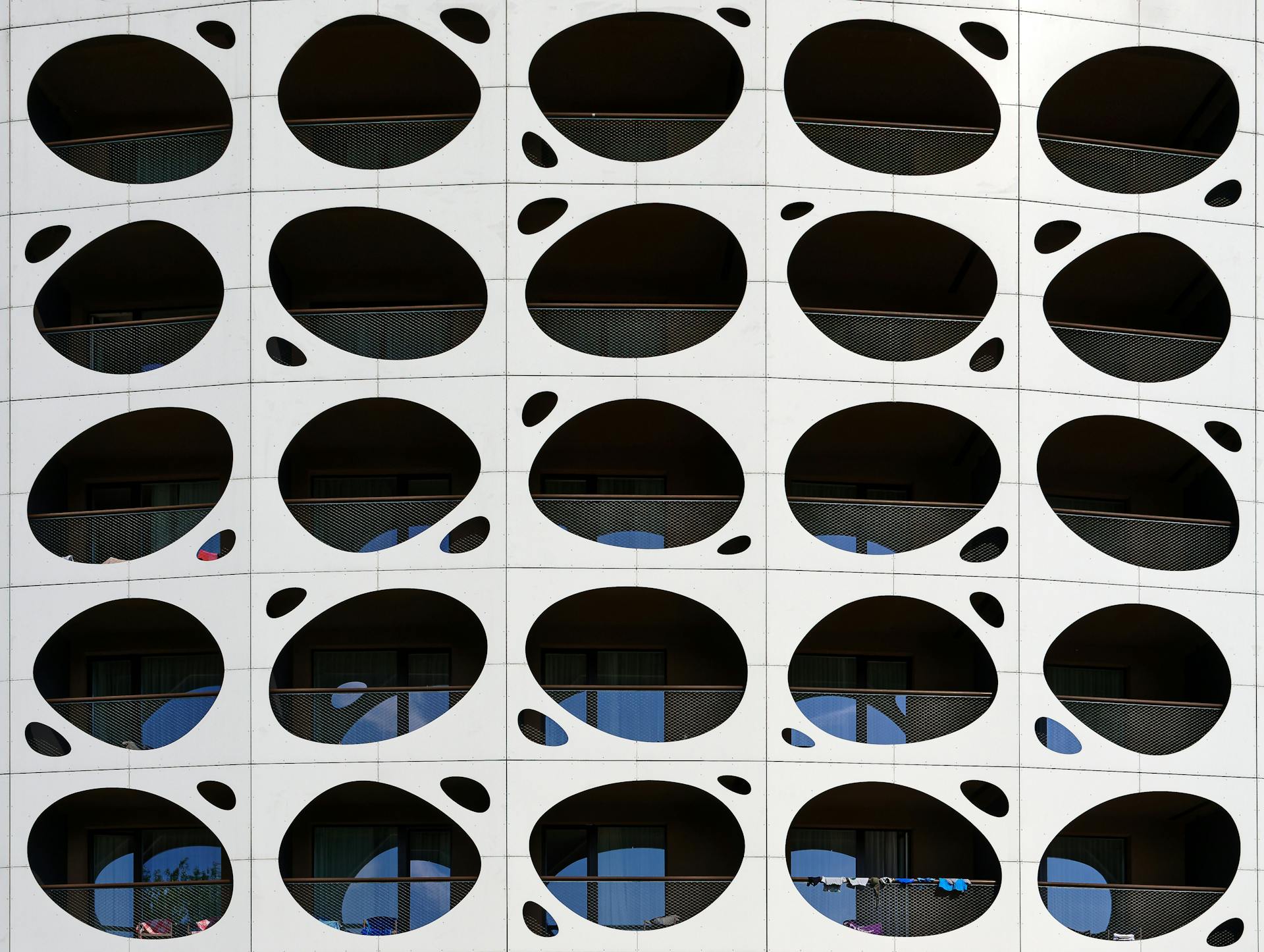 Close-up of a modern building facade featuring a unique geometric design with circular openings.