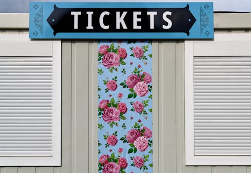 A vibrant ticket booth exterior with floral patterns and bold signage.