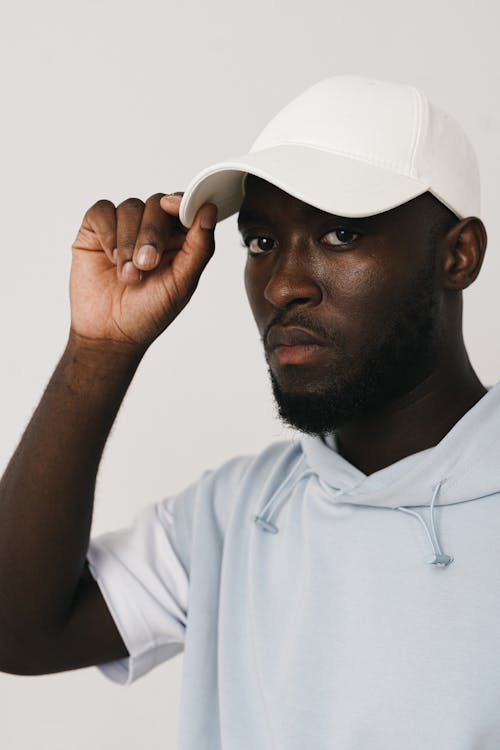 Close Up Photo of Man Wearing White Cap