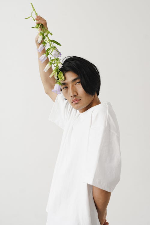 Portrait of a Man Holding a Flower