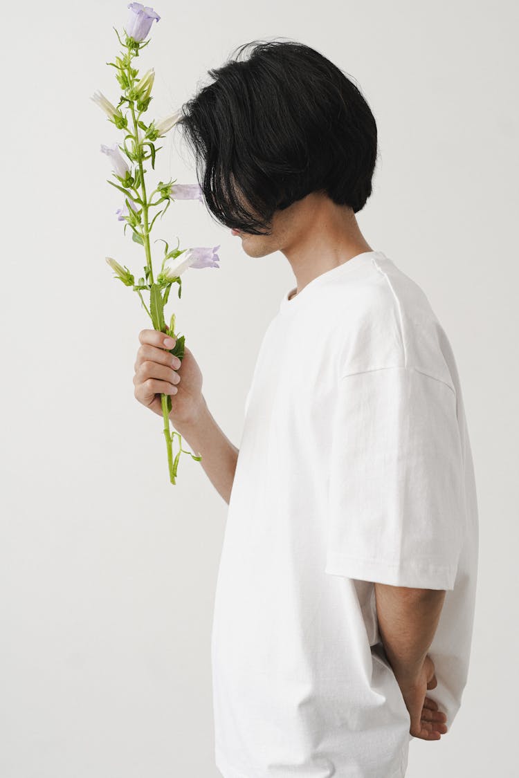 Side View Of A Man Holding Flowers