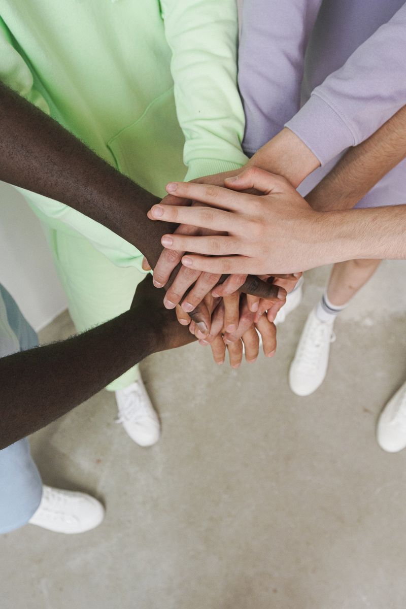 Diverse hands joined together in unity