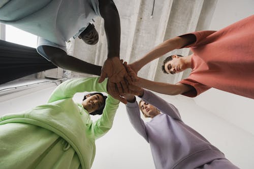 Free Group of Men with Their Hands Together Stock Photo