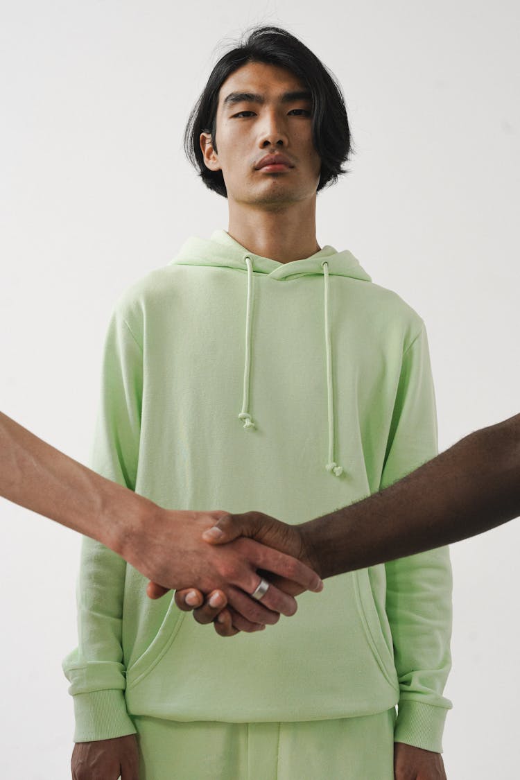 A Man In Green Hoodie Sweater