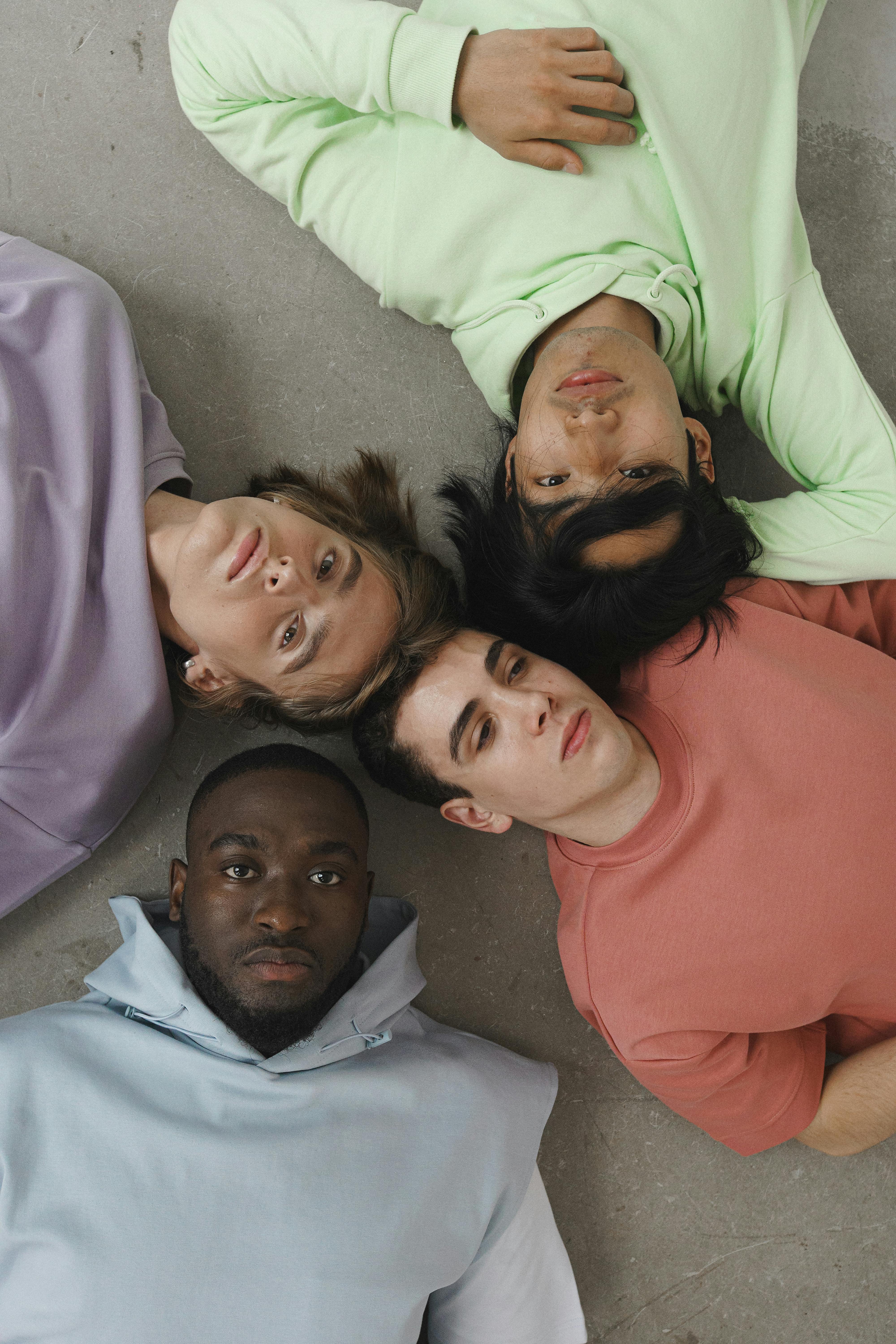 men wearing pastel colored sweaters