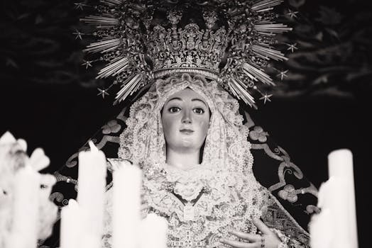 A stunning black and white photo of religious iconography with candles in Sevilla, Spain.