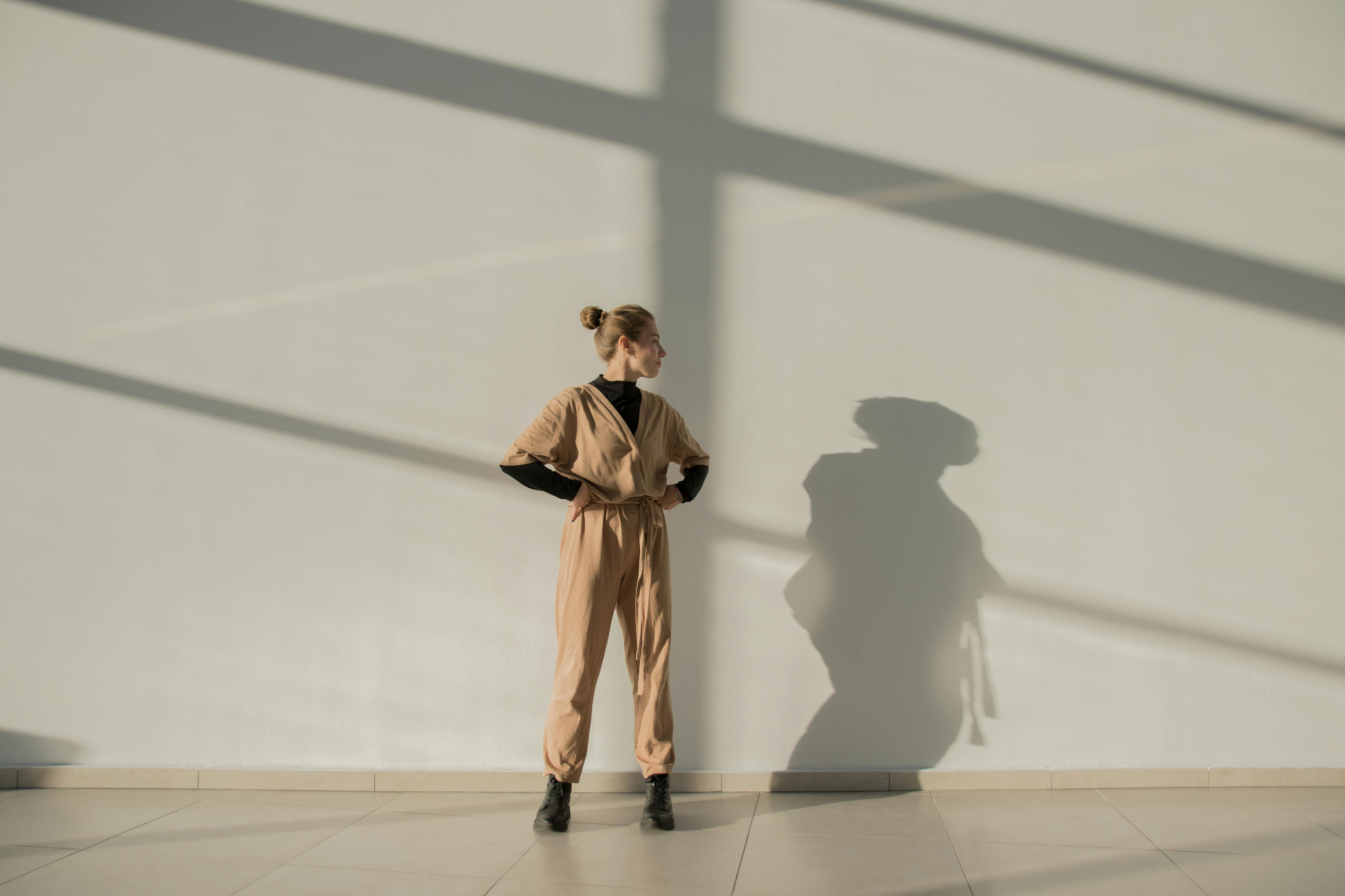 Woman in beige cashmere outfit with no visible logos, elegant and understated