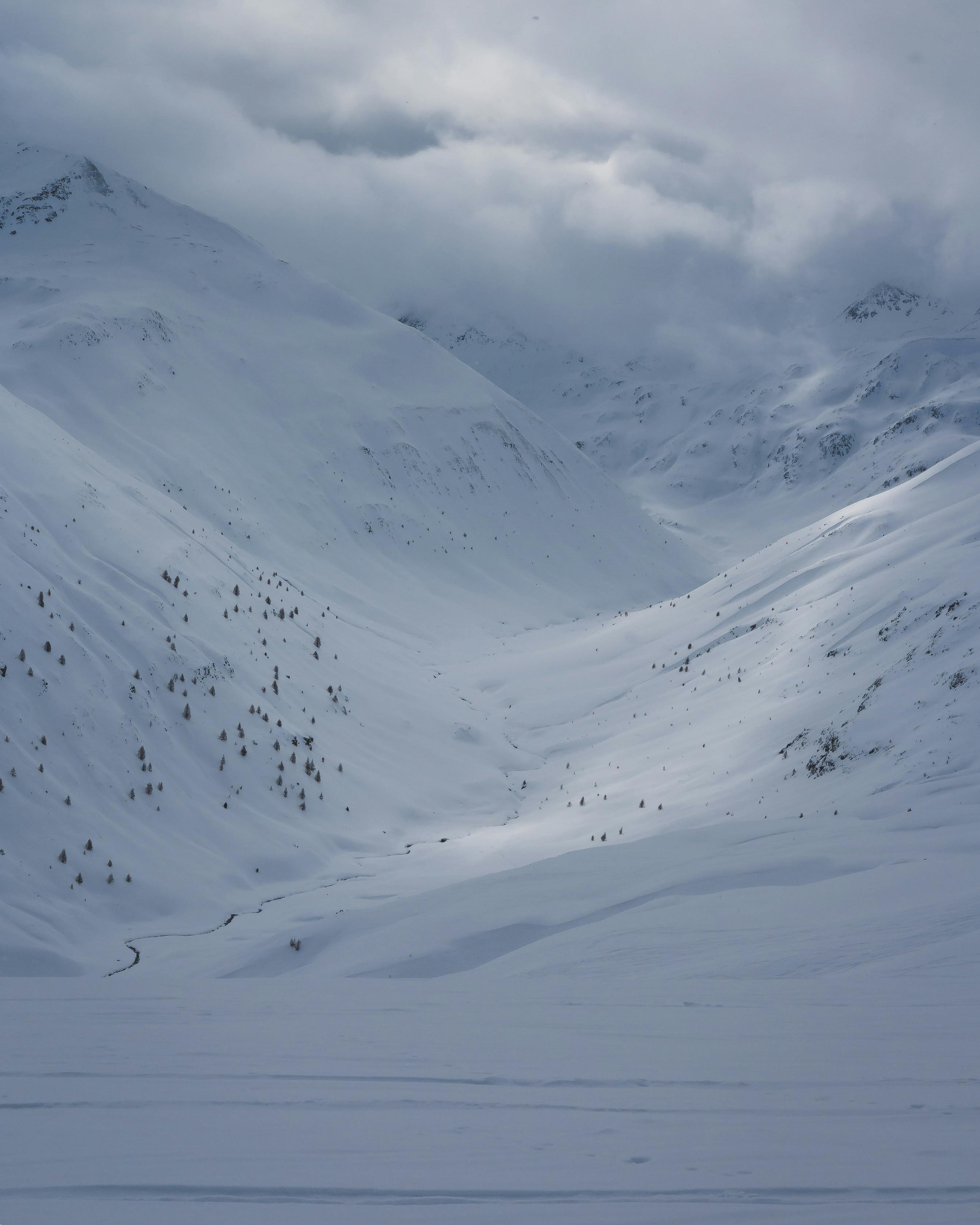 Captivating view of snow-blanketed mountains under moody skies.