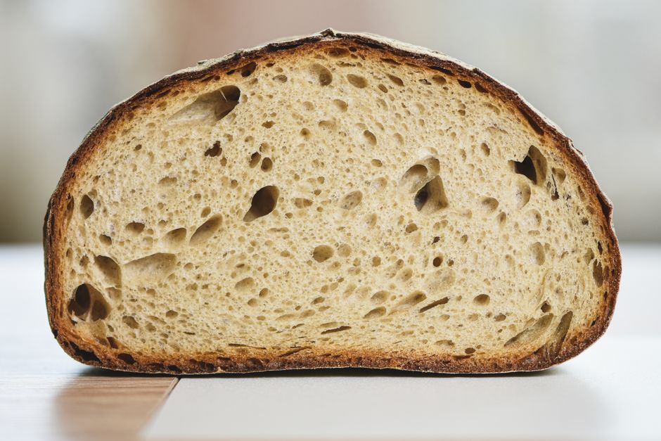 Detailed shot of a crusty artisan sourdough bread slice showcasing its texture and crumb.