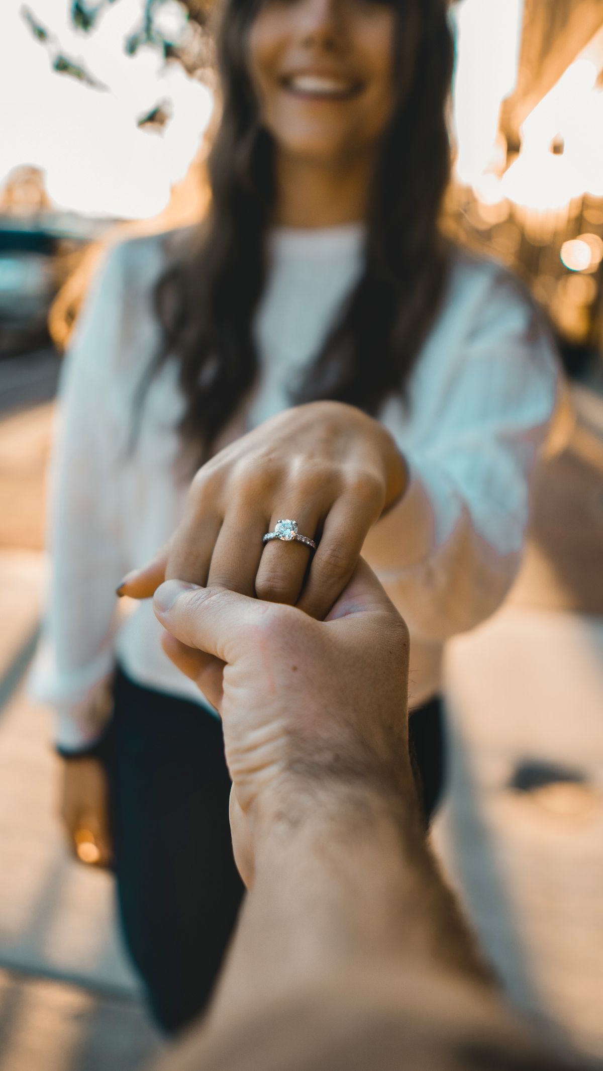 Diamond engagement ring worn on a hand