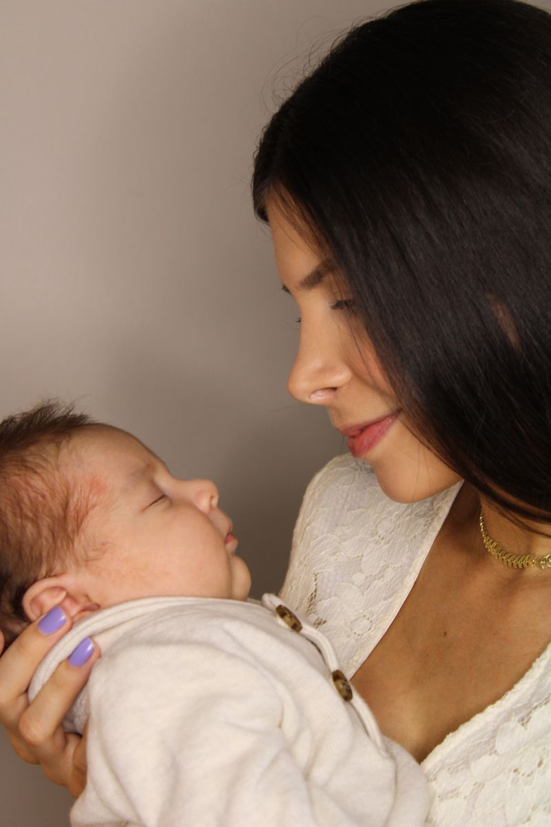 Mother lovingly looking at her newborn baby