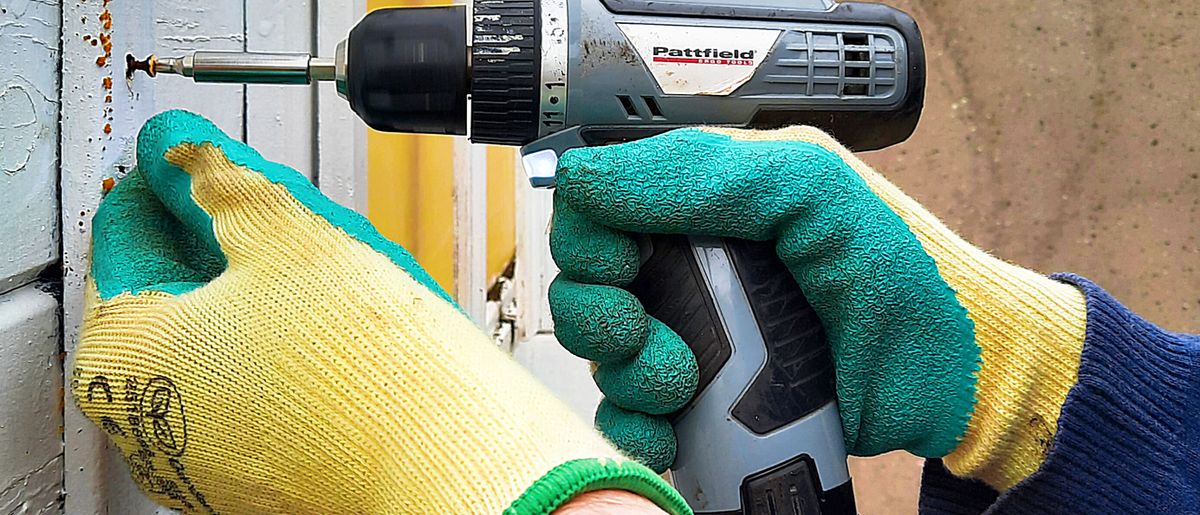 Handyman working through a repair checklist in a home