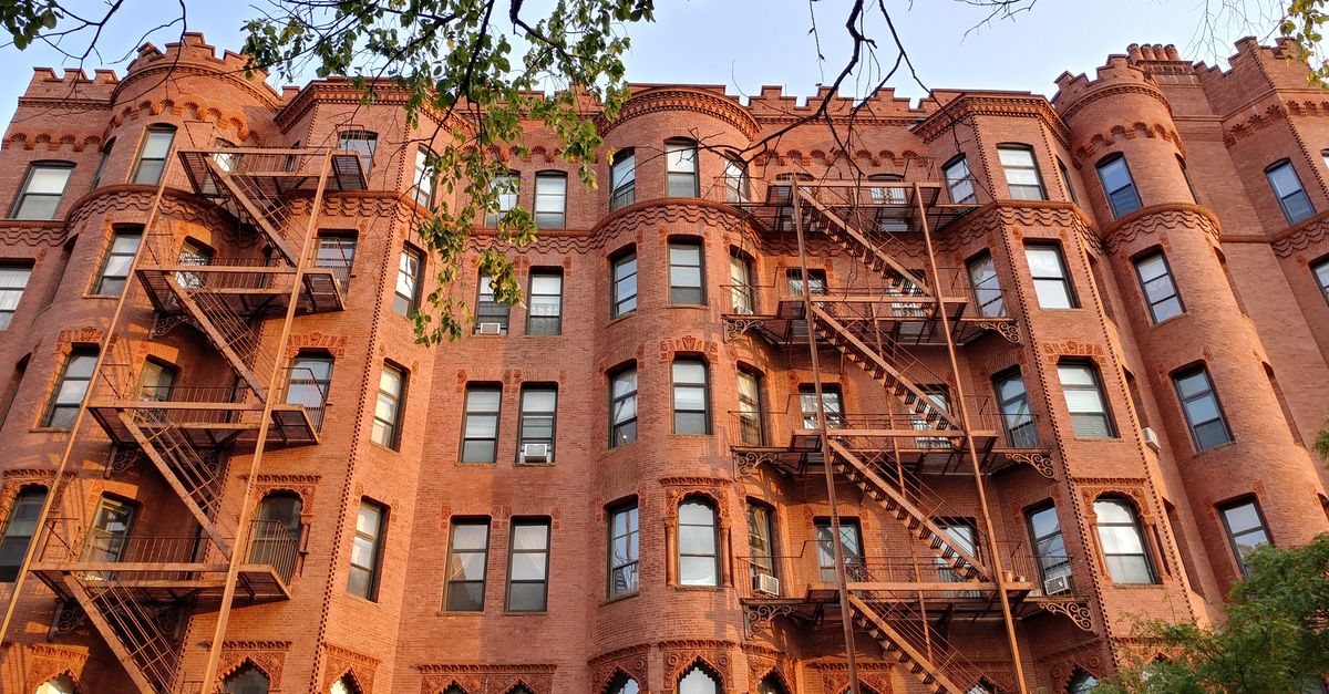 A stunning historic red brick building with distinctive fire escapes and architectural details.