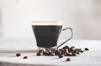Cup of black coffee and coffee beans · Free Stock Photo