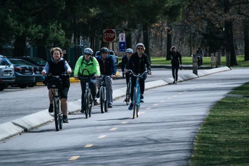 Free A diverse group of cyclists enjoying a ride on a sunny outdoor bike path. Stock Photo
