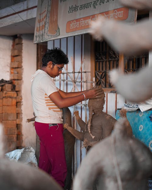 Photo of a Man Making a Sculpture 