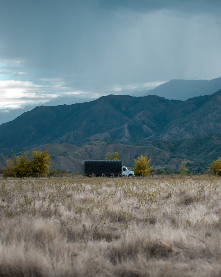 Truck Passing By The Road With Mountain View