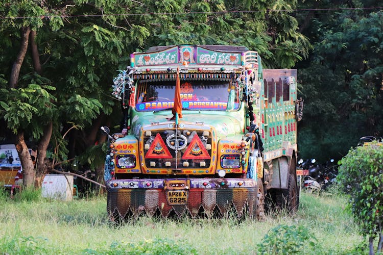 Multicolored Truck Standing Under Trees