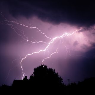 Lightning bolt over a night sky — photo by Nikolett Emmert on Pexels