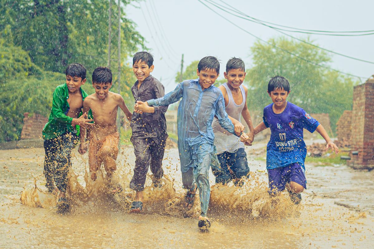 Kids splashing and playing in water on a summer day