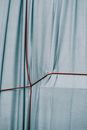 Blue fabric with red strings crossed